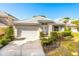 Charming single-story home featuring a tile roof, two-car garage and manicured landscaping at 7264 Hawksnest Blvd, Orlando, FL 32835