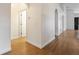 Well-lit hallway with hardwood floors, white trim, and arched doorways at 7264 Hawksnest Blvd, Orlando, FL 32835