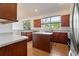 Charming kitchen with cherry wood cabinets, stainless steel appliances, and a functional island at 7264 Hawksnest Blvd, Orlando, FL 32835