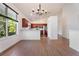 Modern kitchen with stainless steel appliances, cherry wood cabinets, and a central island at 7264 Hawksnest Blvd, Orlando, FL 32835