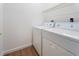 Laundry room with laminate floor and white appliances at 7264 Hawksnest Blvd, Orlando, FL 32835