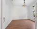 Bright living room features wood floors and a stylish chandelier at 7264 Hawksnest Blvd, Orlando, FL 32835