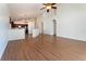 Open-concept living room with hardwood floors and a view of the modern kitchen at 7264 Hawksnest Blvd, Orlando, FL 32835