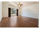 Open living room with wood floors and sliding glass door to patio at 7264 Hawksnest Blvd, Orlando, FL 32835