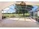 Screened patio with a ceiling fan overlooking a golf course at 7264 Hawksnest Blvd, Orlando, FL 32835