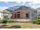 Enclosed screened patio offers a spacious outdoor living area with access to the backyard at 7264 Hawksnest Blvd, Orlando, FL 32835