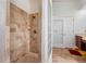 Bathroom shower with travertine tile and pebble floor at 7264 Hawksnest Blvd, Orlando, FL 32835