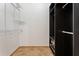 Spacious walk-in closet with custom shelving and neutral tile floors at 7264 Hawksnest Blvd, Orlando, FL 32835