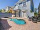 Private backyard with a refreshing kidney-shaped pool, brick-paved patio, and comfortable seating area at 7409 Excitement Dr, Reunion, FL 34747