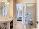 Bright bathroom with a glass shower, a sink, a vanity, and a mirror at 7409 Excitement Dr, Reunion, FL 34747