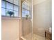 Bathroom with glass enclosed shower featuring neutral toned tiling and a window at 7409 Excitement Dr, Reunion, FL 34747