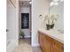 Bathroom with a white vanity, framed mirror, and neutral walls at 7409 Excitement Dr, Reunion, FL 34747
