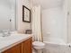 This bathroom features a toilet, a tub, a vanity, a mirror, and artwork at 7409 Excitement Dr, Reunion, FL 34747