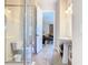 Bathroom view featuring shower with glass door, toilet, sink, and mirror at 7409 Excitement Dr, Reunion, FL 34747