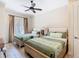 Comfortable bedroom with two beds, ceiling fan, and access to the outdoors at 7409 Excitement Dr, Reunion, FL 34747