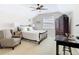 Spacious bedroom with a ceiling fan, a desk, and a comfortable chair at 7409 Excitement Dr, Reunion, FL 34747