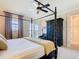 Bedroom with a dark, four-poster bed with white linens, a ceiling fan, and carpet flooring at 7409 Excitement Dr, Reunion, FL 34747