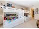 ' bedroom featuring two sets of white bunk beds with colorful decor and carpeted floors at 7409 Excitement Dr, Reunion, FL 34747