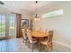 Bright dining area with a round wooden table, comfortable seating, and natural light at 7409 Excitement Dr, Reunion, FL 34747