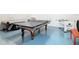 Spacious game room featuring a ping pong table, foosball table, and pool table, perfect for entertainment at 7409 Excitement Dr, Reunion, FL 34747