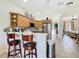 Inviting kitchen featuring light wood cabinets, stainless steel appliances, and a breakfast bar with seating at 7409 Excitement Dr, Reunion, FL 34747