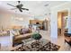 Open-concept living room boasts a ceiling fan and flows into the kitchen and dining area at 7409 Excitement Dr, Reunion, FL 34747