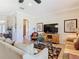 Cozy living room features neutral tones, a ceiling fan, and lots of natural light at 7409 Excitement Dr, Reunion, FL 34747