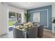 Dining room with sliding doors to the patio and stylish decor with accent wall at 756 Mocking Jay Ln, St Cloud, FL 34771