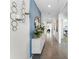 Inviting hallway with blue accent wall, decorative mirror, and elegant console table at 756 Mocking Jay Ln, St Cloud, FL 34771