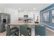 Bright kitchen featuring a granite island, stainless steel appliances, and sleek bar stools at 756 Mocking Jay Ln, St Cloud, FL 34771