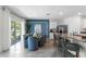 Open-concept kitchen and dining area with breakfast bar and adjacent patio access at 756 Mocking Jay Ln, St Cloud, FL 34771