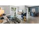 Bright living room adjacent to dining area with large windows and stylish furniture at 756 Mocking Jay Ln, St Cloud, FL 34771