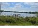 Lakeside view of a wooden dock surrounded by lush vegetation, creating a tranquil and private retreat at 8129 Granada Blvd, Orlando, FL 32836