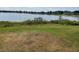 Scenic backyard view showcasing the lake, providing a serene and natural setting near the home at 8129 Granada Blvd, Orlando, FL 32836