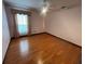 A quaint bedroom features hardwood floors, ceiling fan and a window at 8129 Granada Blvd, Orlando, FL 32836