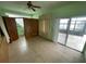 Bright bedroom with sliding glass doors leading to a patio and scenic lake views at 8129 Granada Blvd, Orlando, FL 32836