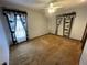 Large, carpeted bedroom features a ceiling fan, closet and picture window at 8129 Granada Blvd, Orlando, FL 32836