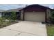 Spacious driveway leading to a two-car garage with stone and siding exterior at 8129 Granada Blvd, Orlando, FL 32836