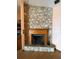 Close up shot of stone fireplace with hearth and wooden mantelpiece at 8129 Granada Blvd, Orlando, FL 32836