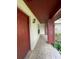 Inviting covered front porch featuring decorative tile flooring and a stylish light fixture at 8129 Granada Blvd, Orlando, FL 32836