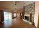 Open living room with a stone fireplace and sliding glass doors to patio at 8129 Granada Blvd, Orlando, FL 32836