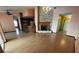 Open living room with stone fireplace and hardwood floors leading to an eat-in kitchen at 8129 Granada Blvd, Orlando, FL 32836