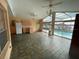 Large sunroom featuring tiled floors, ceiling fans, and direct access to the pool and lake views at 8129 Granada Blvd, Orlando, FL 32836