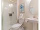 Clean bathroom showcasing a glass shower, toilet, and pedestal sink with modern fixtures at 8844 Cabot Cliffs Dr, Davenport, FL 33896