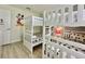 This bedroom features two sets of white bunk beds with Mickey Mouse themed decor at 8844 Cabot Cliffs Dr, Davenport, FL 33896