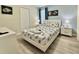 This bedroom features a white platform bed with seashell-patterned bedding and two nightstands with lamps at 8844 Cabot Cliffs Dr, Davenport, FL 33896