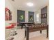 Fun game room complete with foosball table, air hockey, and dart board for entertainment at 8844 Cabot Cliffs Dr, Davenport, FL 33896