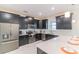 Stylish kitchen with dark cabinets, quartz countertops, and stainless steel appliances at 8844 Cabot Cliffs Dr, Davenport, FL 33896
