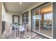 Cozy covered patio with outdoor dining set perfect for relaxing and entertaining at 8844 Cabot Cliffs Dr, Davenport, FL 33896