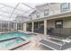 Inviting backyard features a screened-in pool, spa, and lounge area at 8844 Cabot Cliffs Dr, Davenport, FL 33896